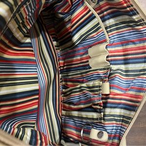 MAXX purse with striped inside lining.